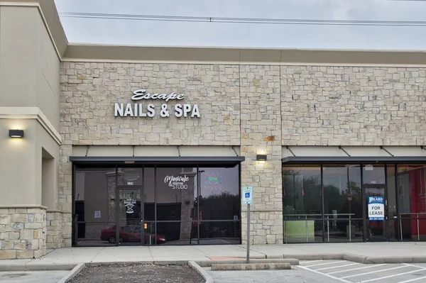 An image of a sign installation near Barker nails and spa