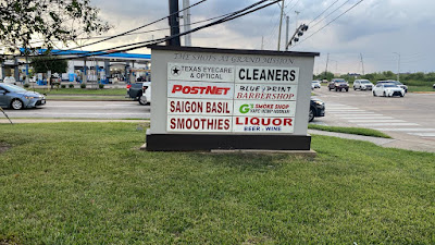 Roadside monument sign for The Shops at Grand Mission listing multiple businesses, illustrating building signs Houston for commercial use.