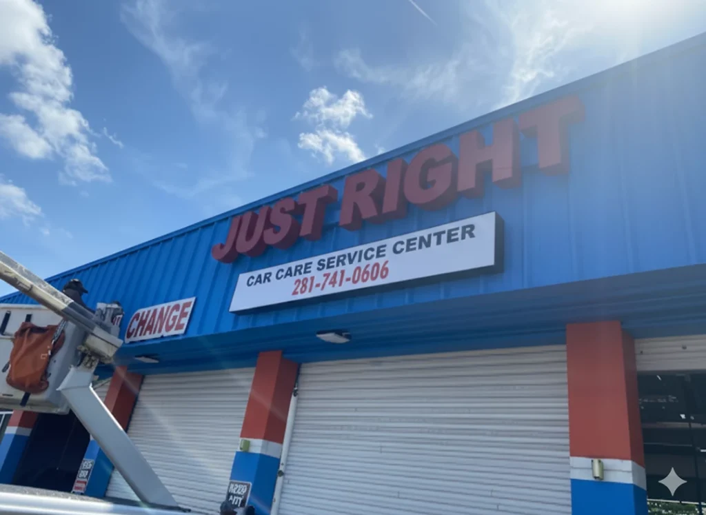 Bright "Just Right Car Care Service Center" sign being installed, crafted by expert business signs Houston.