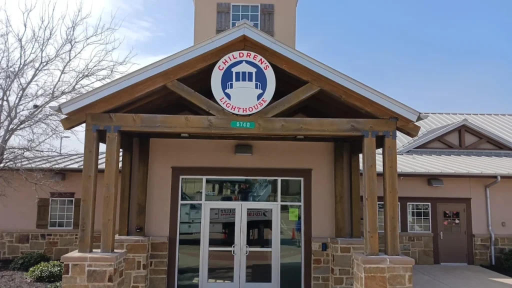 Welcoming entrance of Children's Lighthouse with sign, featuring a lighthouse logo and address 5740, ideal for family care services.