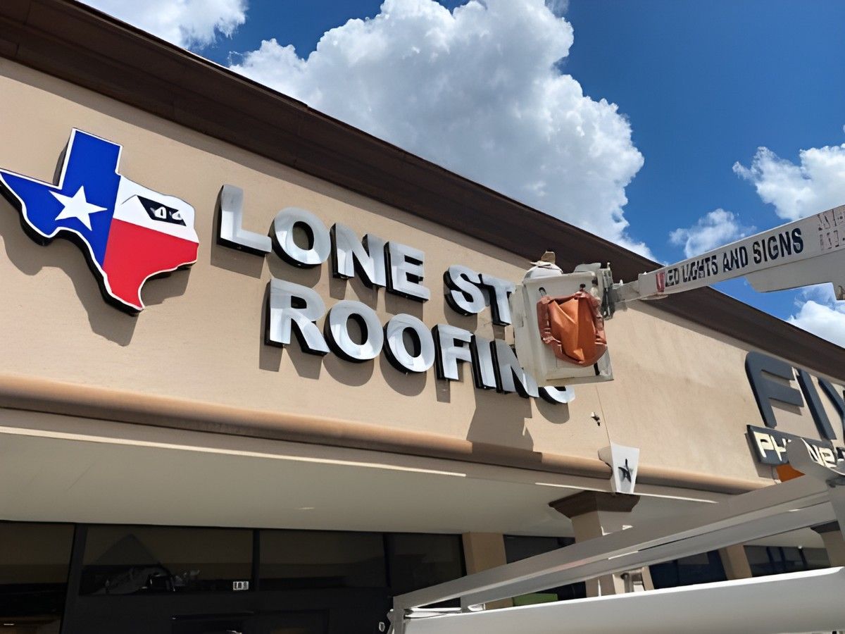 Worker installing a Lone Star Roofing sign with a Signage Company Houston, showcasing professional installation.