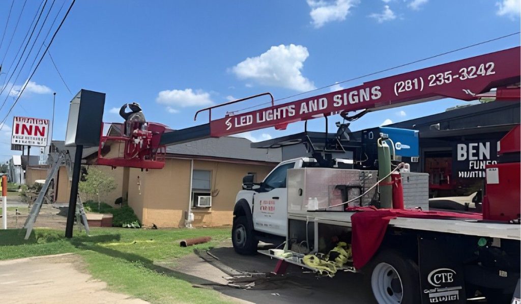 Truck and crew setting up a sign with a Signage Company Houston, ensuring quality outdoor signage solutions.