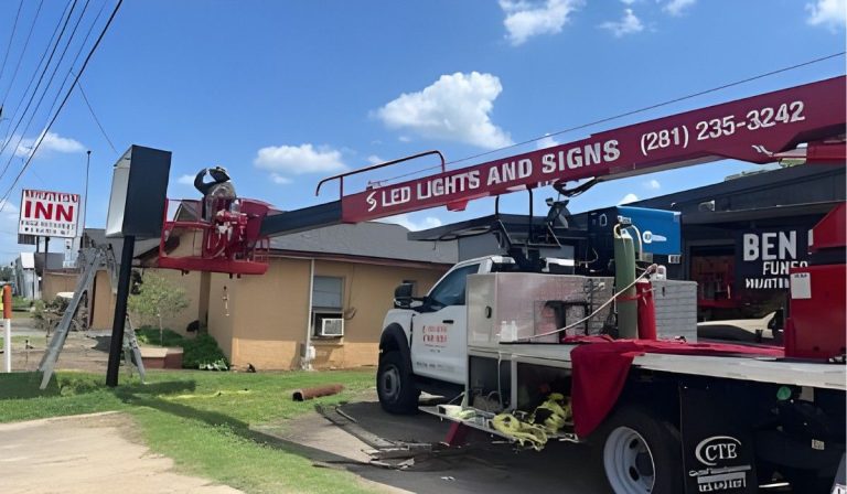 Truck and crew setting up a sign with a Signage Company Houston, ensuring quality outdoor signage solutions.
