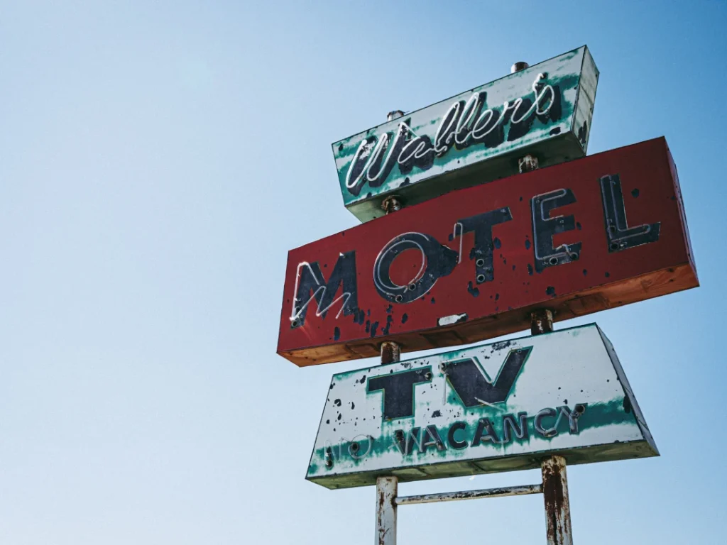 Vintage Weller's Motel sign with TV ad at a top business signs Houston shop, offering custom retro signage solutions.
