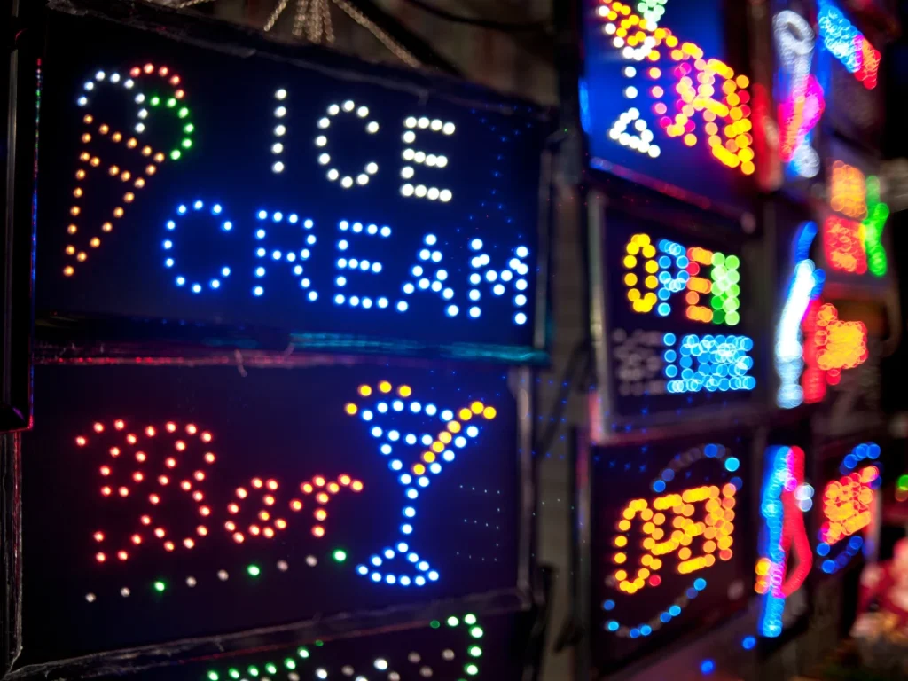 Bright neon ICE CREAM sign from a leading business signs Houston provider, specializing in eye-catching commercial displays.