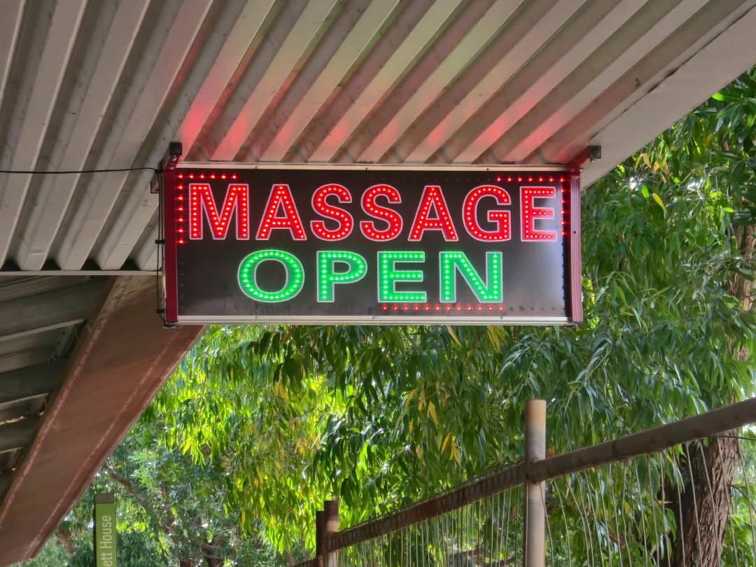 Glowing MASSAGE OPEN sign by a premier business signs Houston company, creating effective and vibrant advertising signs.