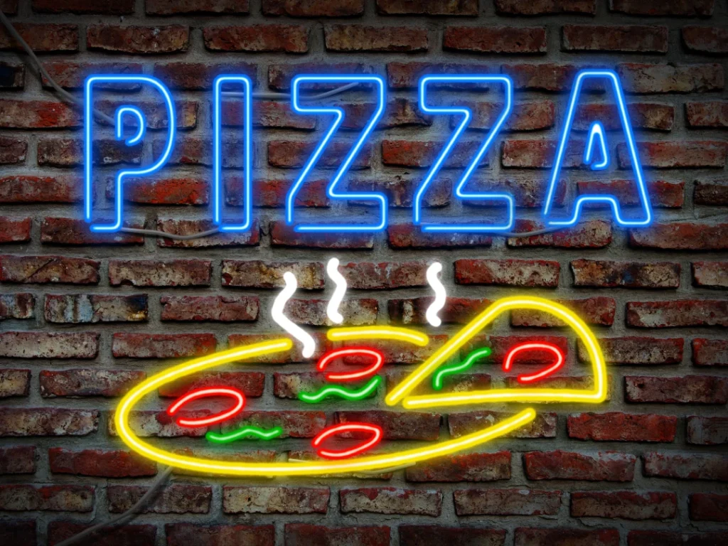 Vibrant neon PIZZA sign with a slice image from a top business sign manufacturer in Houston, crafting unique commercial signs.