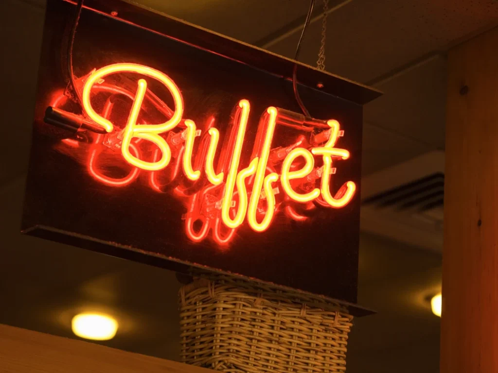 Glowing neon Buffet sign from a top business sign manufacturer in Houston, creating vibrant indoor signage for businesses.