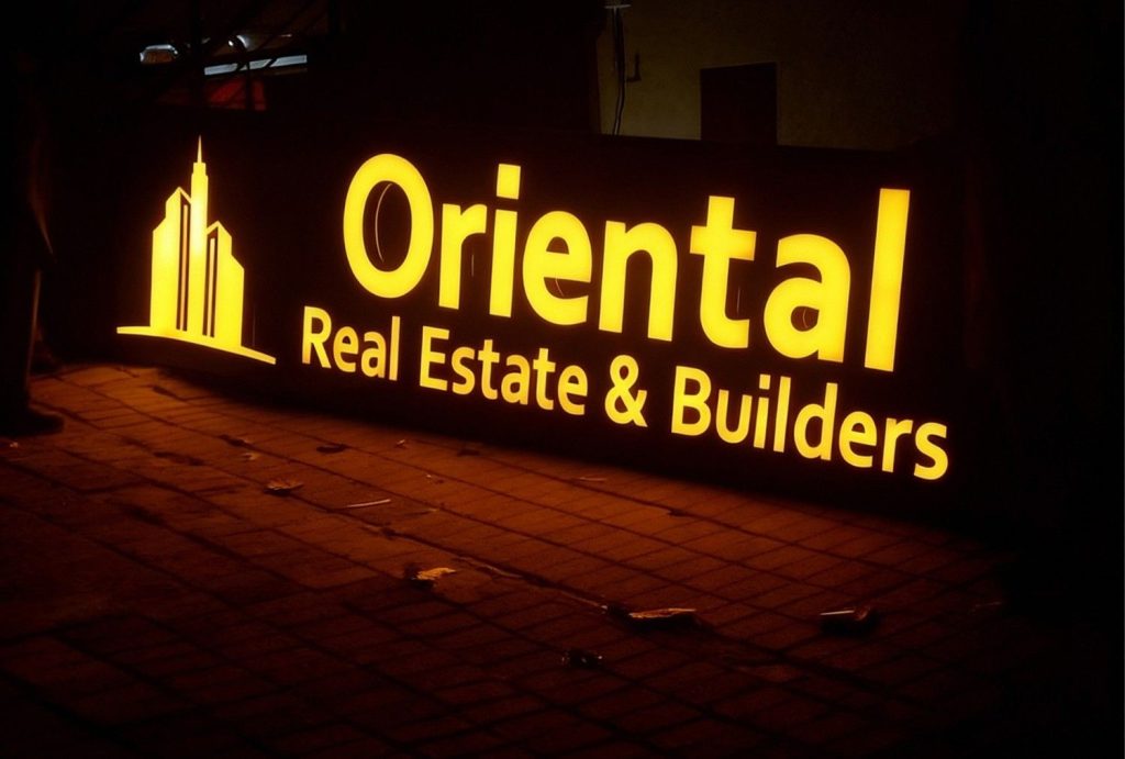 Premium golden halo lit channel letters for Oriental Real Estate & Builders – high-end halo lit channel letters houston at night