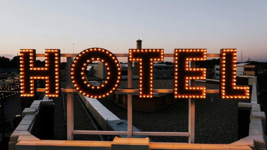 Vintage-style rooftop 'HOTEL' sign with long-lasting LED bulbs, custom manufactured for events and permanent installation by a Houston event signage company, demonstrating the extended lifespan and energy efficiency of modern LED lighting technology.
