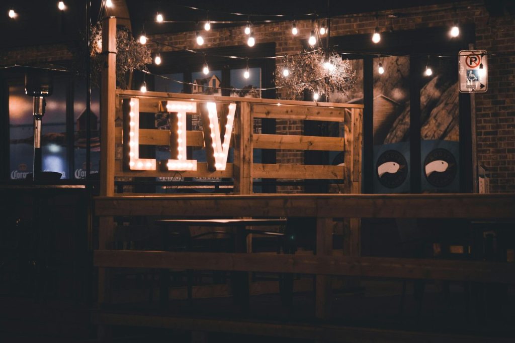 Rustic wooden 'LIVE' marquee sign with long-lasting LED bulbs, custom-designed and built by a Houston event signage company, perfect for weddings, parties, and venues – showcasing the durability and energy efficiency of modern LED lighting.
