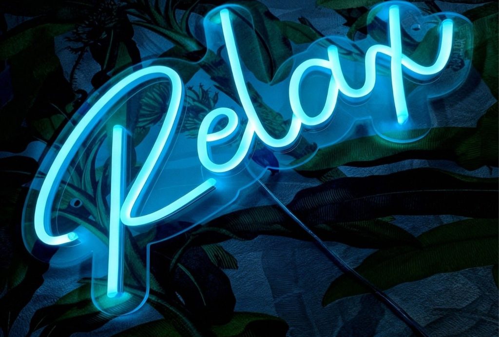 Tropical-inspired ice-blue "Relax" custom LED neon sign – modern signage design houston for spas and lounges