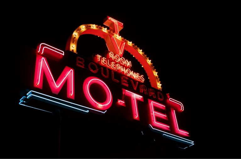Vintage Boulevard Motel neon outdoor signs for businesses Houston, displaying glowing red lights against the dark.