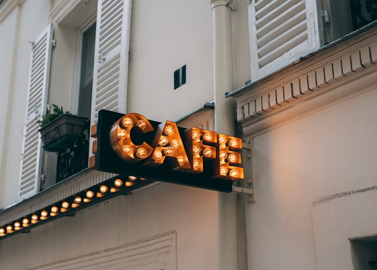 A classic marquee-style bulb sign for a cafe. We are the premier business sign manufacturer Houston for vintage looks.