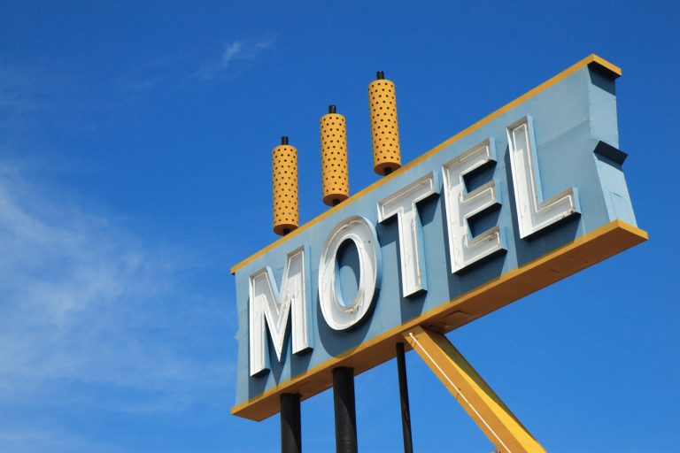 Vintage roadside motel sign near Houston, Texas. Retro pylon sign installation. Top-rated custom building signs Houston.
