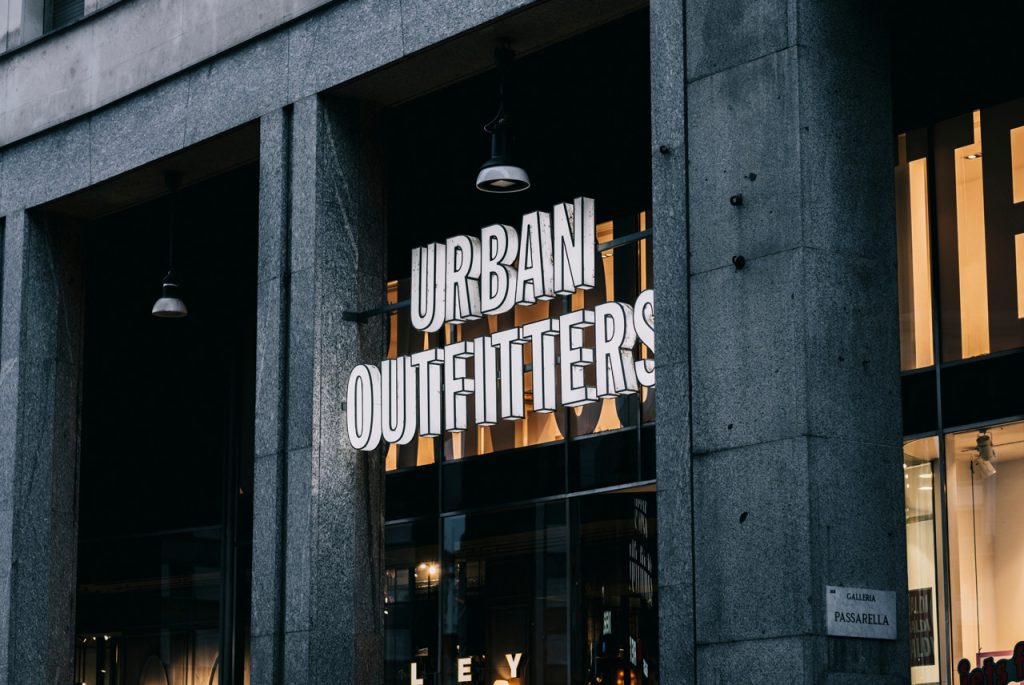 Large backlit 3D block outdoor signs for businesses Houston retail storefront for Urban Outfitters on stone facade.