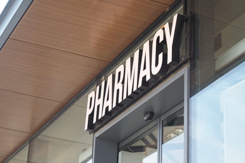 Illuminated channel letter building signs Houston: Modern pharmacy exterior signage. High-quality retail building signs Houston.