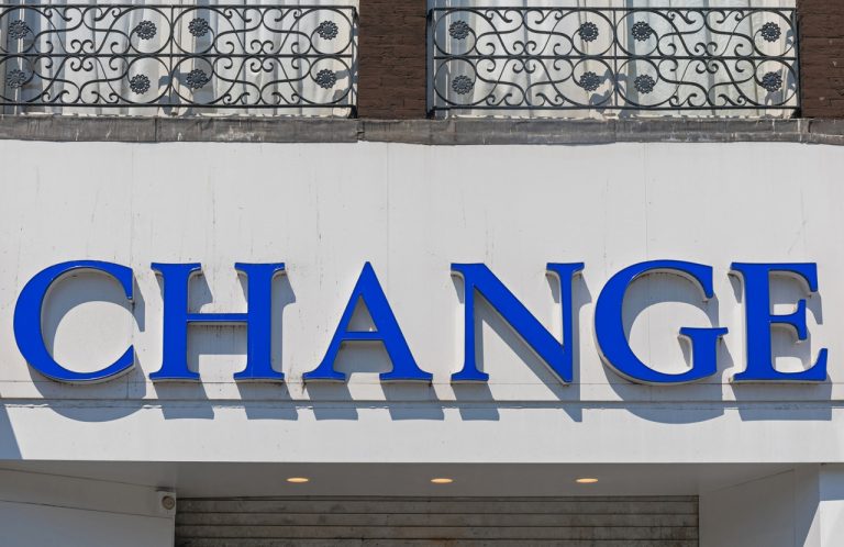Blue 3D dimensional letters for a currency exchange, showcasing professional Houston commercial signs on a facade.