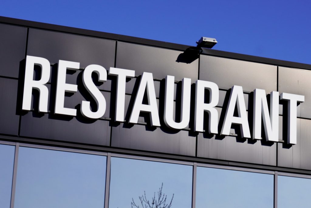 Modern white channel letter restaurant signage, highlighting sleek Houston commercial signs for local storefronts.