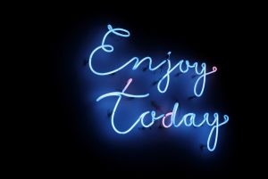 Blue cursive enjoy today interior wall neon sign for home or office from a top-rated sign manufacturer Houston.