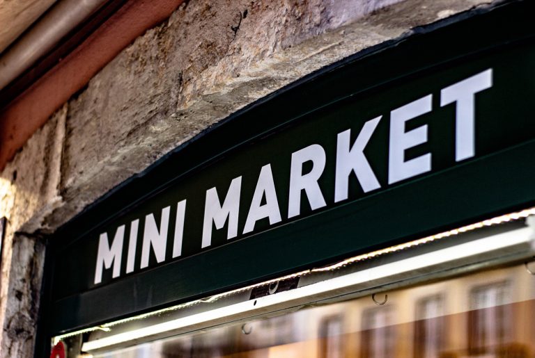 Professional mini market vinyl fascia storefront sign created by a local sign manufacturing Houston expert.