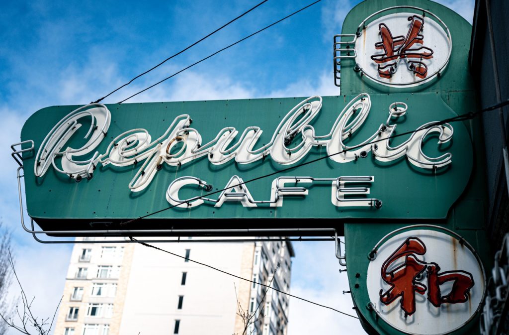 Vintage neon Republic Cafe building signs Houston with Chinese characters and a teal green mid-century aesthetic.