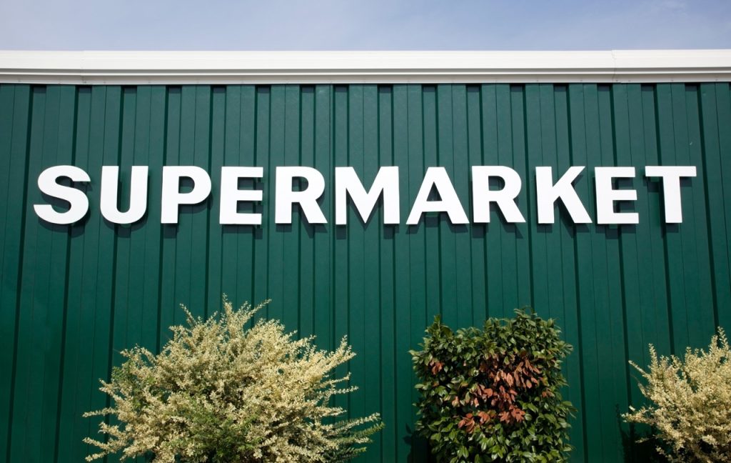 Large white supermarket outdoor lettering installed by a leading sign manufacturing Houston specialist.