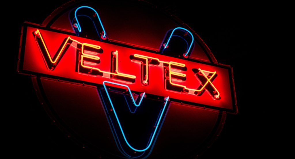 Vintage red and blue Veltex gas station neon display by a premier provider of custom signs Houston businesses trust.