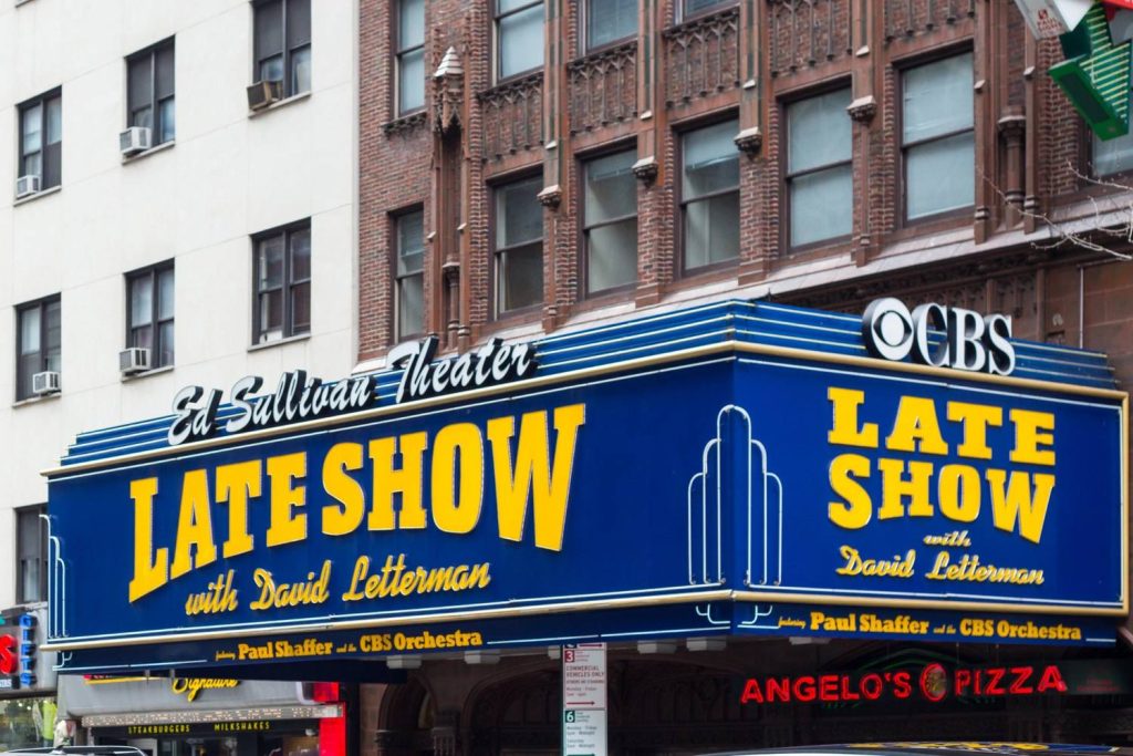 Ed Sullivan Theater marquee for Late Show with David Letterman showing iconic business signs Houston style in New York.
