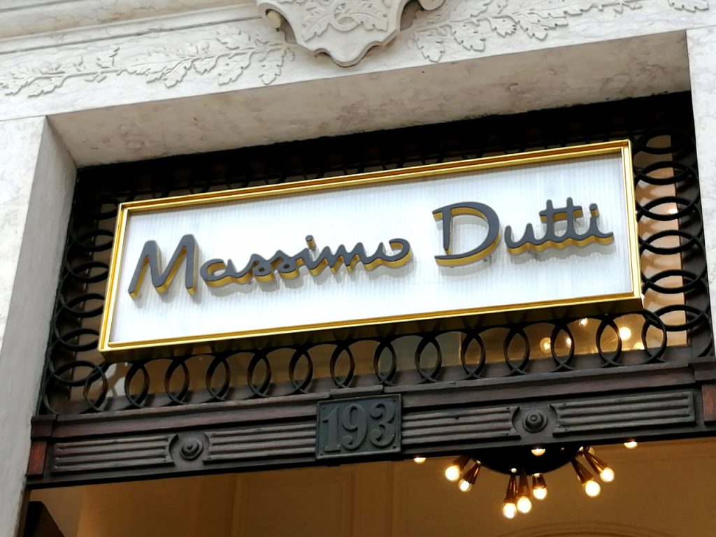 Elegant custom signs Houston for luxury retail stores with gold trim accents and sophisticated backlit lettering.