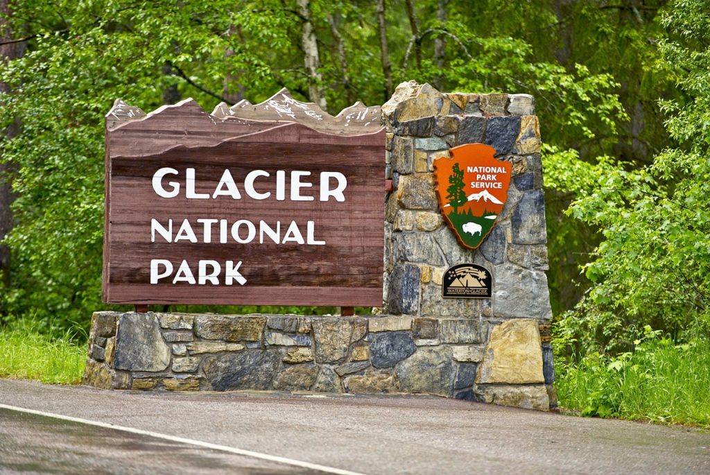 Rustic wood design outdoor signs for businesses Houston inspired by the Glacier National Park timber and stone sign.