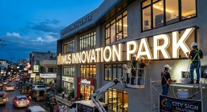 Professional installation of custom signs Houston at Imus Business Center featuring large backlit channel letters.