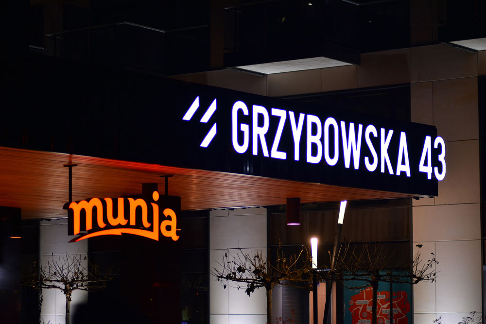 Custom backlit channel letters and modern storefront signage designed by a sign company Houston for night visibility.