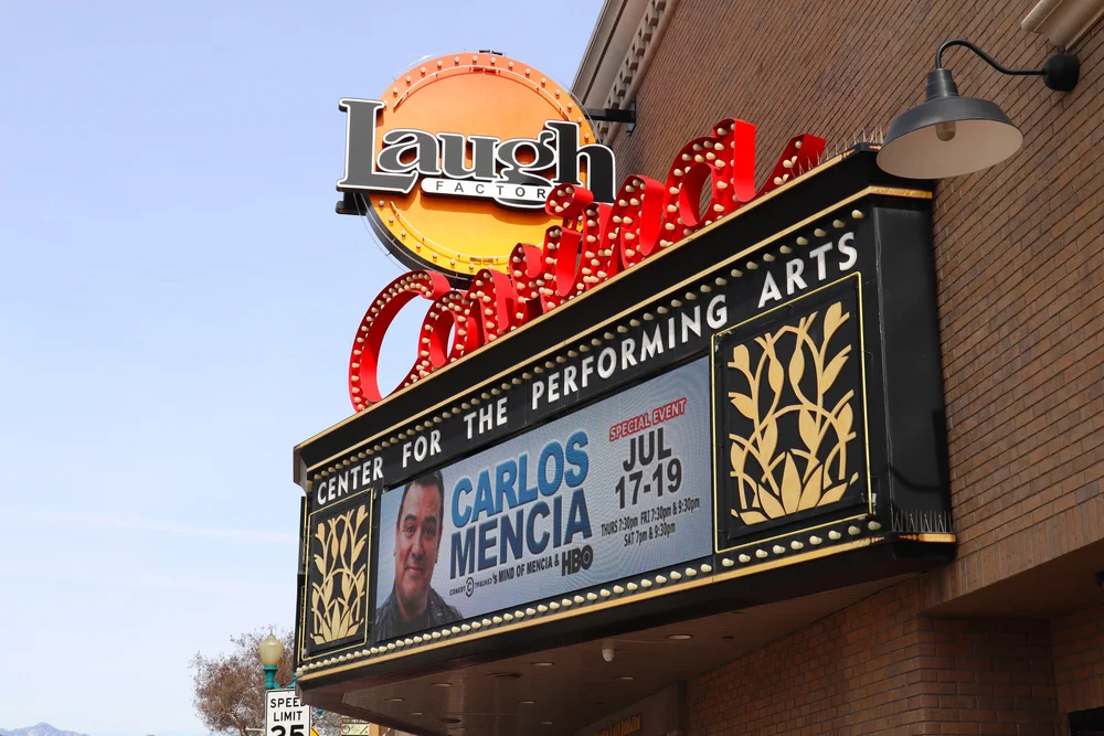 Historic Coronado theater marquee promoting Carlos Mencia with colorful LED and neon, featuring ornate Event Signage houston.