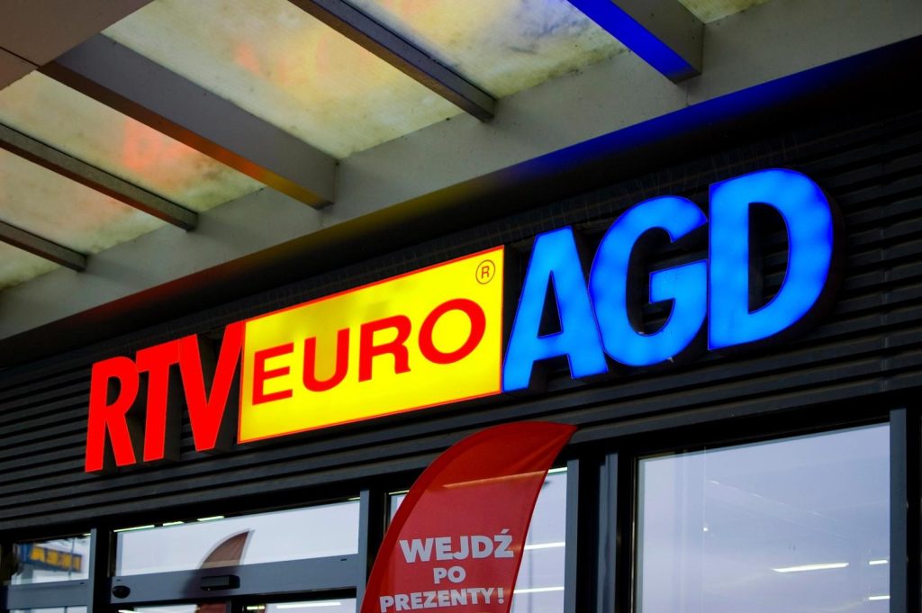 Vibrant RTV EURO AGD retail office signs featuring bold red, yellow, and blue 3D channel letters on a dark facade.