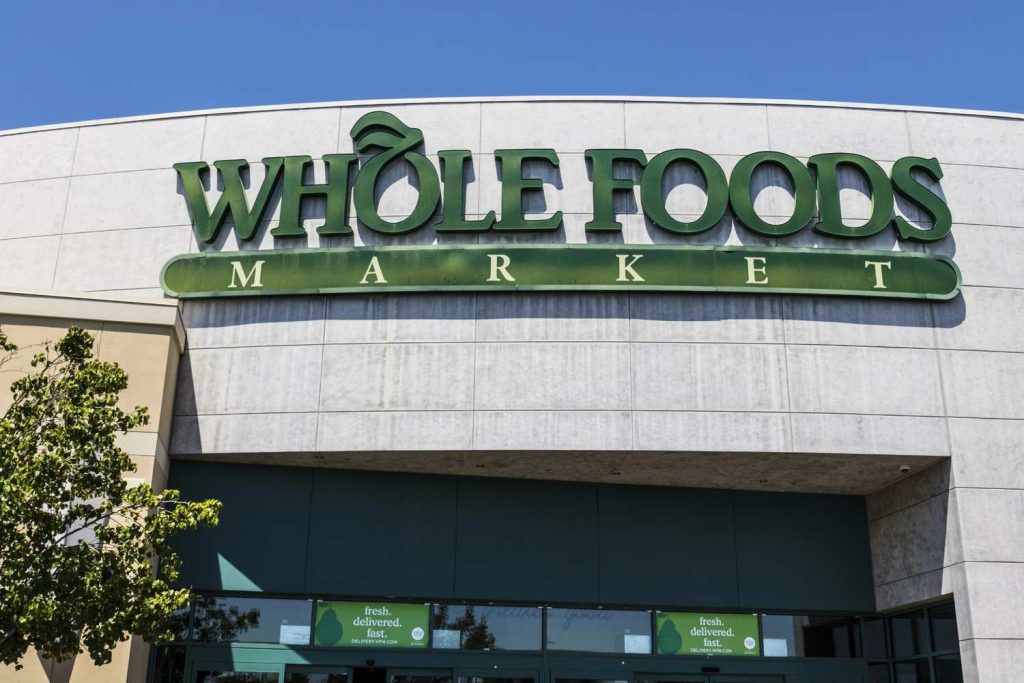 Custom illuminated Whole Foods Market storefront display by a premier business sign manufacturer Houston company. 