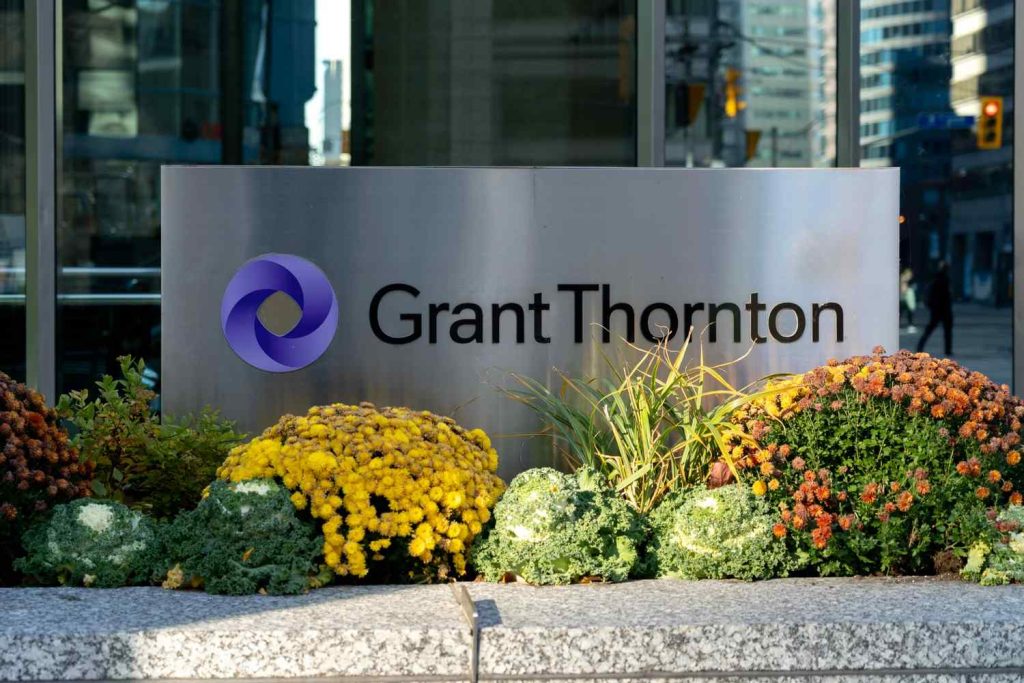 Modern brushed metal Grant Thornton office monument sign provided by a top-rated local signage company Houston.