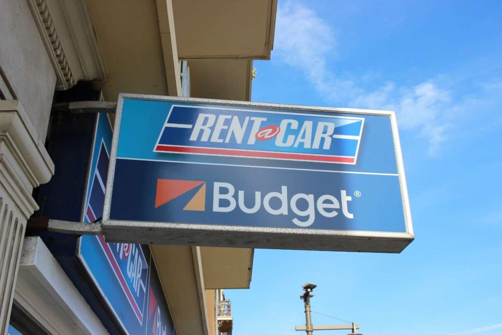Blue Budget Rent a Car outdoor advertising display matching standard styles for Houston commercial signs. 